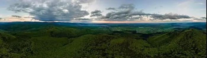 Framed Print : Aerial wide panoramic view of dark mountain hills covered with green mixed pine and lush forest in evening Framed Print : Aerial wide panoramic view of dark mountain hills covered with green mixed pine and lush forest in evening