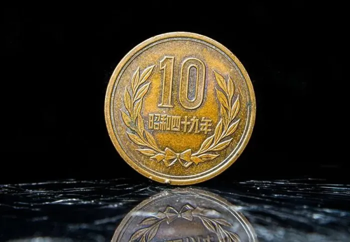 Framed Print : An aged penny sitting atop a table, displaying 10 Yen - Heisei, Japanese coin