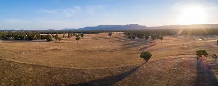 Framed Print : Agricultural land with mountains in the background at sunset - aerial panoramic landscape Framed Print : Agricultural land with mountains in the background at sunset - aerial panoramic landscape