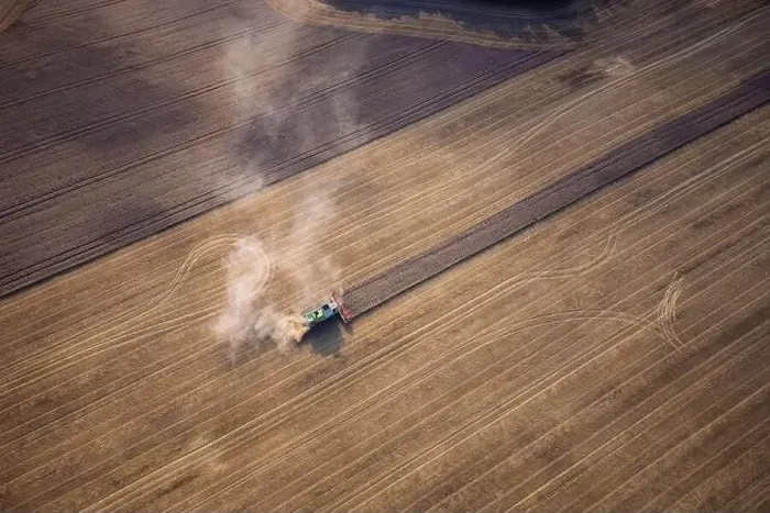 Framed Print : Agricultural machines harvest wheat in the field. Aerial shot from above. There is a lot of dust around the harvester Framed Print : Agricultural machines harvest wheat in the field. Aerial shot from above. There is a lot of dust around the harvester
