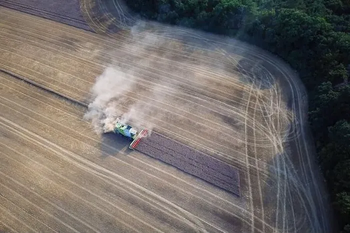 Framed Print : Agricultural machines harvest wheat in the field. Aerial shot from above. There is a lot of dust around the harvester Framed Print : Agricultural machines harvest wheat in the field. Aerial shot from above. There is a lot of dust around the harvester