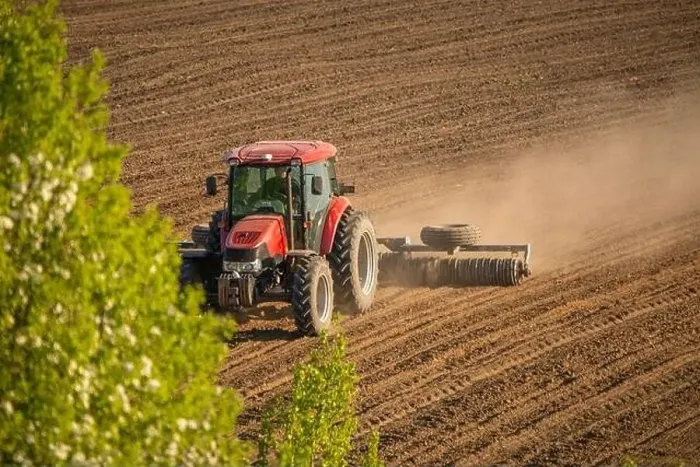 Framed Print : Agricultural Symphony: Tractor Cultivating the Field Framed Print : Agricultural Symphony: Tractor Cultivating the Field