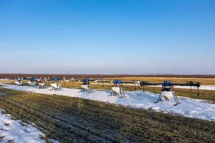 Framed Print : Many agrodrones are on the green field. The snow has not melted yet. Agrodrons are ready to spray fertilizer