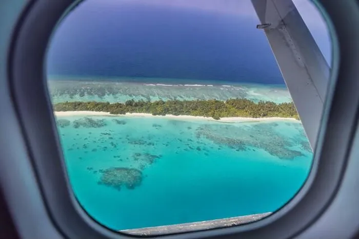 Framed Print : Airplane window with beautiful Maldives island view. Luxury summer holiday travel tourism background, view from airplane window. Atolls islands Framed Print : Airplane window with beautiful Maldives island view. Luxury summer holiday travel tourism background, view from airplane window. Atolls islands