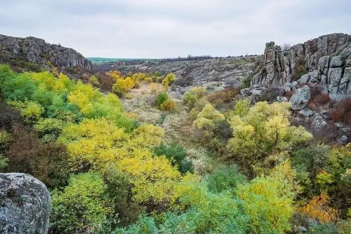 Framed Print : Aktovsky Canyon, Ukraine. Autumn trees and large stone boulders around Framed Print : Aktovsky Canyon, Ukraine. Autumn trees and large stone boulders around