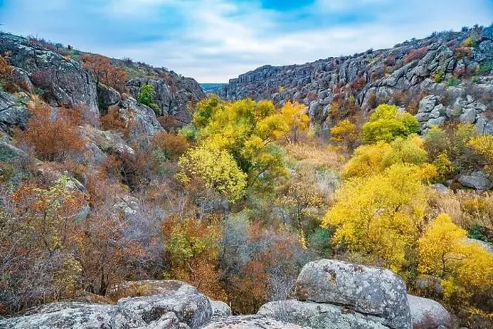 Framed Print : Aktovsky Canyon, Ukraine. Autumn trees and large stone boulders around Framed Print : Aktovsky Canyon, Ukraine. Autumn trees and large stone boulders around