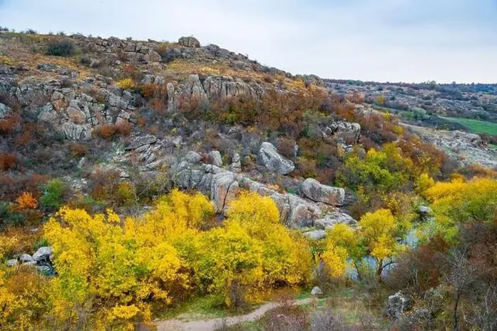 Framed Print : Aktovsky Canyon, Ukraine. Autumn trees and large stone boulders around Framed Print : Aktovsky Canyon, Ukraine. Autumn trees and large stone boulders around