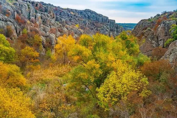 Framed Print : Aktovsky Canyon, Ukraine. Autumn trees and large stone boulders around Framed Print : Aktovsky Canyon, Ukraine. Autumn trees and large stone boulders around
