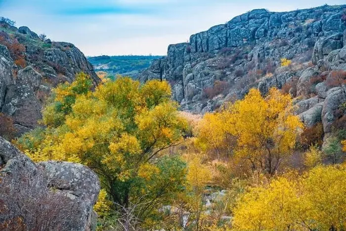 Framed Print : Aktovsky Canyon, Ukraine. Autumn trees and large stone boulders around Framed Print : Aktovsky Canyon, Ukraine. Autumn trees and large stone boulders around