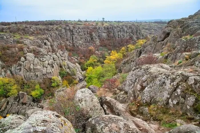 Framed Print : Aktovsky Canyon, Ukraine. Autumn trees and large stone boulders around Framed Print : Aktovsky Canyon, Ukraine. Autumn trees and large stone boulders around