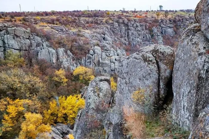 Framed Print : Aktovsky Canyon, Ukraine. Autumn trees and large stone boulders around Framed Print : Aktovsky Canyon, Ukraine. Autumn trees and large stone boulders around