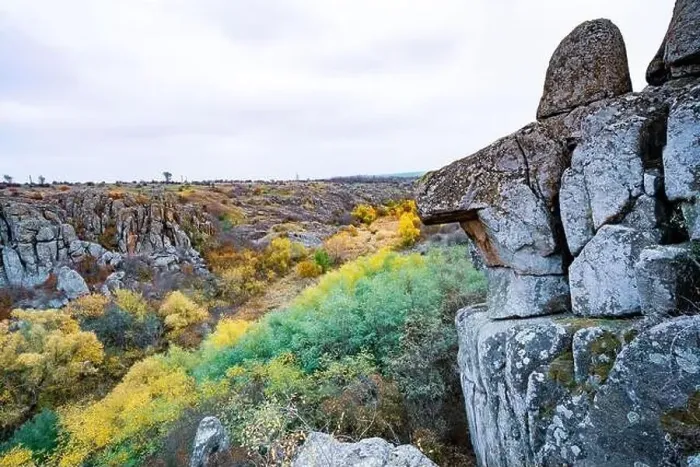 Framed Print : Aktovsky Canyon, Ukraine. Autumn trees and large stone boulders around Framed Print : Aktovsky Canyon, Ukraine. Autumn trees and large stone boulders around