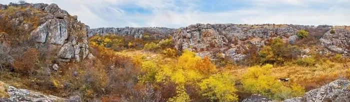 Framed Print : Aktovsky Canyon, Ukraine. Autumn trees and large stone boulders around Framed Print : Aktovsky Canyon, Ukraine. Autumn trees and large stone boulders around