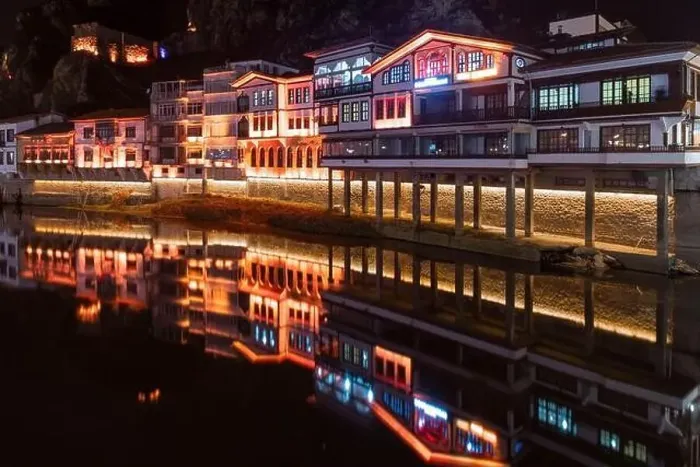 Framed Print : Amasya, Turkey - December 22, 2022 : Old Ottoman houses and clock tower view by the Yesilirmak River in Amasya City