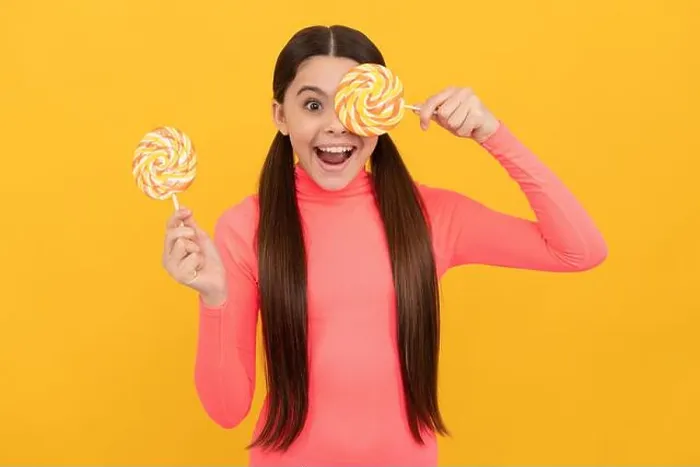 Framed Print : amazed teen girl with lollipop candy on stick on yellow background, sweet tooth Framed Print : amazed teen girl with lollipop candy on stick on yellow background, sweet tooth