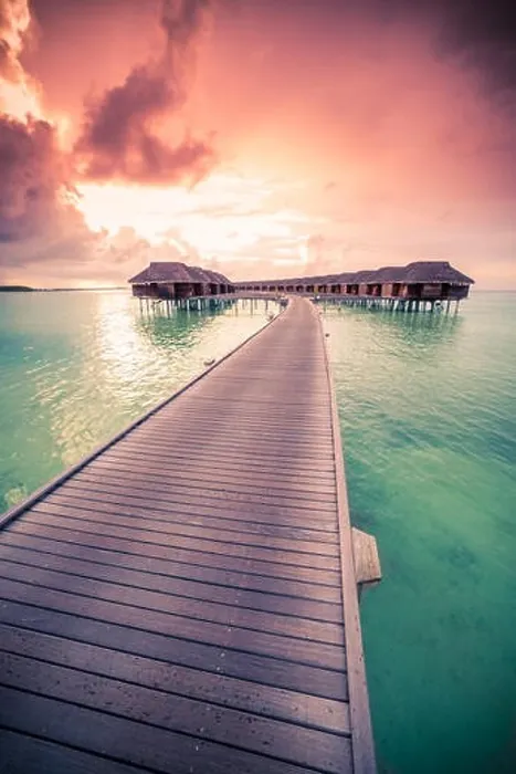 Framed Print : Amazing abstract background. Beautiful sunset colors in Maldives. Long jetty and luxury overwater villas Framed Print : Amazing abstract background. Beautiful sunset colors in Maldives. Long jetty and luxury overwater villas