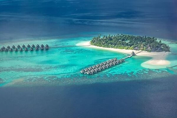 Amazing aerial landscape, luxury tropical resort or hotel with water villas and beautiful beach scenery. Perfect bird eyes view in Maldives, landscape