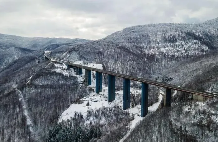 Framed Print : Amazing aerial view of a road. Stunning snow landscape with river and trees Framed Print : Amazing aerial view of a road. Stunning snow landscape with river and trees