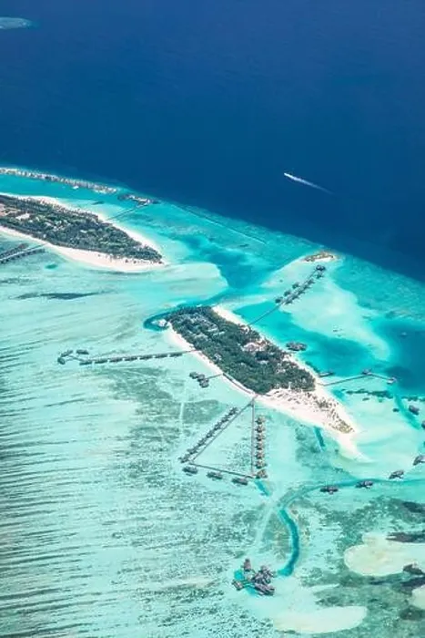 Framed Print : Amazing bird eyes view in Maldives from plane or drone. Luxury resort hotel water villas bungalows. Summer vacation holiday landscape destination