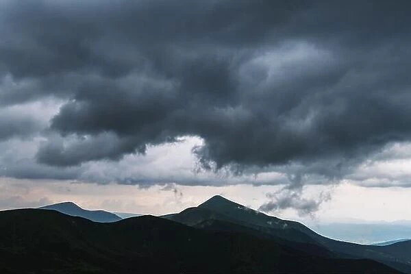 Amazing flowing rainy clouds in evening mountains. Beautiful nature of Carpathians. Landscape photography