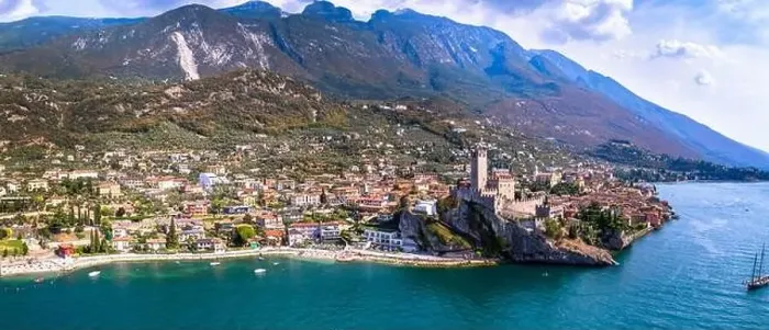 Framed Print : Amazing italian lake scenery - beautiful Lago di Garda. Aerial view of Malcesine castle, vilage and beach