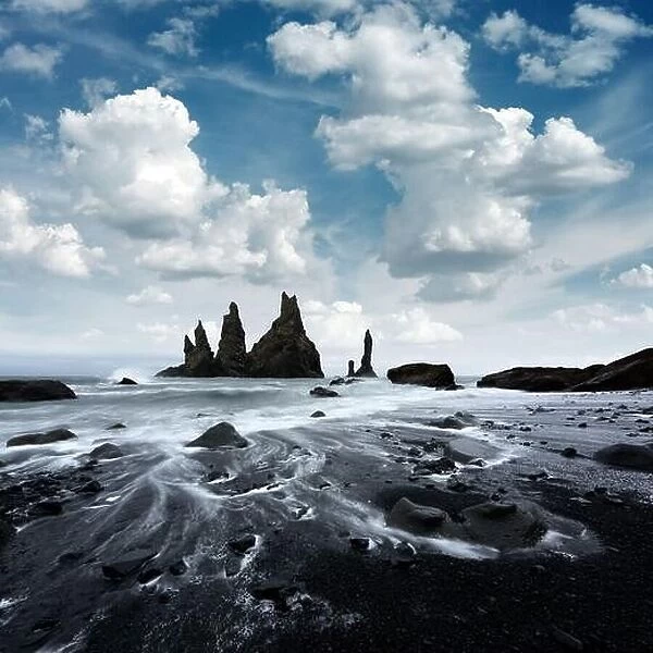 Amazing landscape with basalt rock formations Troll Toes on Black beach, stormy ocean waves and cloudscape. Reynisdrangar, Vik, Iceland