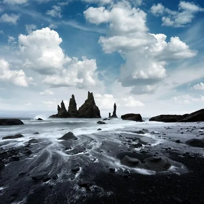 Framed Print : Amazing landscape with basalt rock formations Troll Toes on Black beach, stormy ocean waves and cloudscape. Reynisdrangar, Vik, Iceland