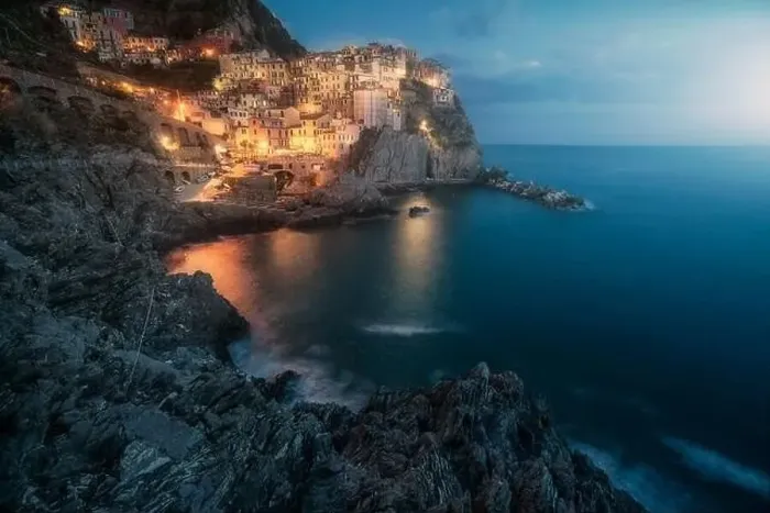 Framed Print : Amazing landscape with small town with colorful lights on rocky coast washing by tranquil ocean water at night Framed Print : Amazing landscape with small town with colorful lights on rocky coast washing by tranquil ocean water at night