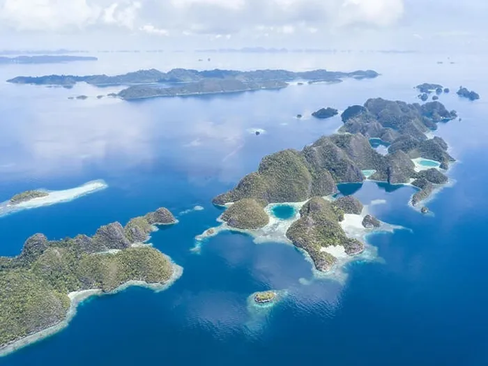 Framed Print : Amazing limestone islands rise from the calm seascape around Misool, Raja Ampat, Indonesia. This tropical region harbors amazing marine biodiversity Framed Print : Amazing limestone islands rise from the calm seascape around Misool, Raja Ampat, Indonesia. This tropical region harbors amazing marine biodiversity