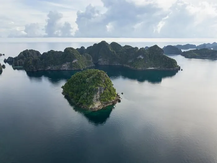 Framed Print : Amazing limestone islands rise from the calm seascape around Misool, Raja Ampat, Indonesia. This tropical region harbors amazing marine biodiversity Framed Print : Amazing limestone islands rise from the calm seascape around Misool, Raja Ampat, Indonesia. This tropical region harbors amazing marine biodiversity