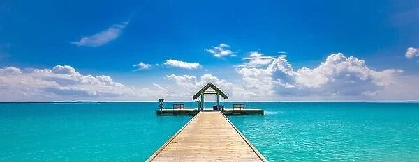 Amazing seascape panorama at Maldives. Luxury resort villas seascape under sunny blue sky. Water bungalow and jetty, ocean lagoon