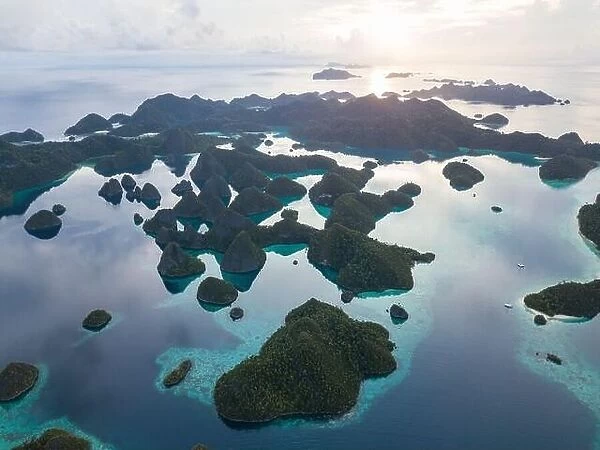 An amazing set of limestone islands are found in a remote part of Raja Ampat, Indonesia. These tropical islands are surrounded by healthy coral reefs