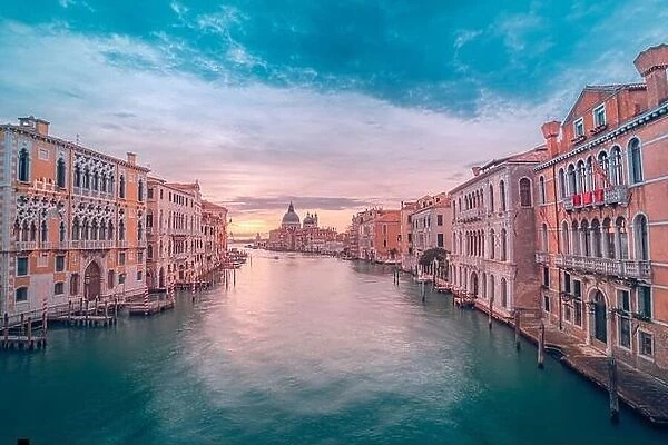 Amazing summer travel landscape. Stunning sunrise sunset over Grand Canal and Basilica Santa Maria della Salute in Venice, Italy. Relaxing colors