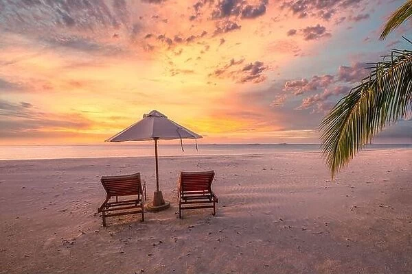 Amazing sunset beach. Romantic couple chairs umbrella. Tranquil togetherness love concept scenery, relax beach, beautiful landscape design. Getaway