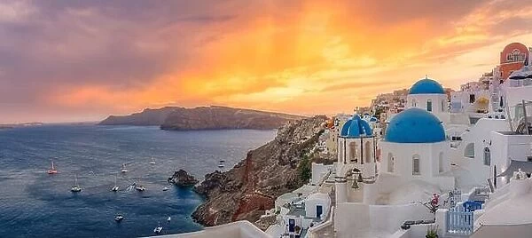 Amazing sunset panoramic landscape, luxury travel vacation. Oia town on Santorini island, Greece. Traditional famous houses and churches blue domes