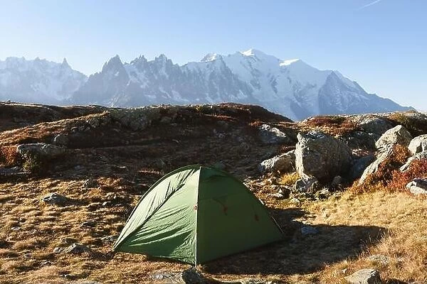 Amazing view on Monte Bianco mountains range with green tent and Monblan on background. Vallon de Berard Nature Preserve, Chamonix, Graian Alps
