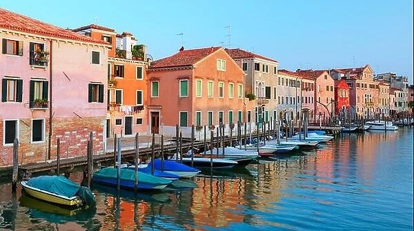 Amazing view on morning Venice. Row of boats and glowing colourful houses. Italy, Europe