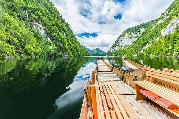 Amazing wooden boats on lake with reflection of mountain and sky. Freedom and adventure concept. Beautiful nature concept, mountain nature