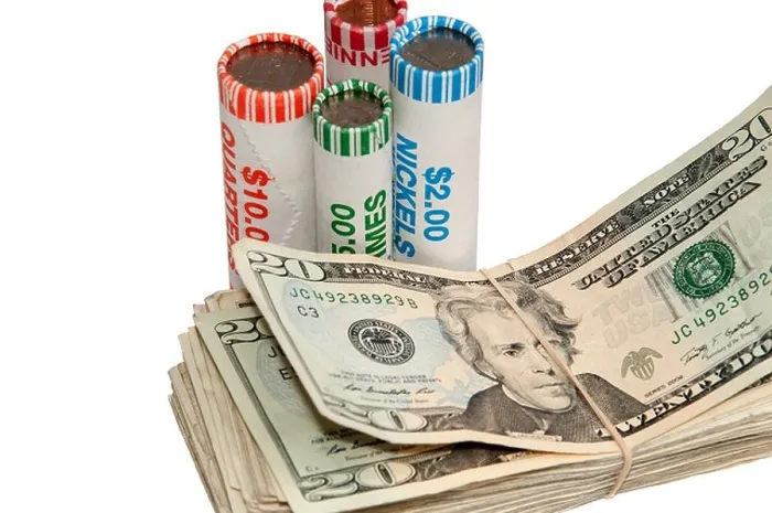Framed Print : American currency with stacks of bills and rolls of coins standing next to them Framed Print : American currency with stacks of bills and rolls of coins standing next to them