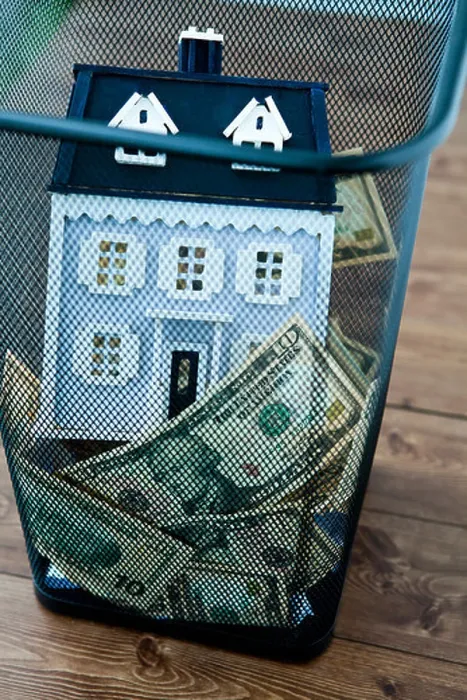 Framed Print : American dollar bills and model home in garbage can Framed Print : American dollar bills and model home in garbage can