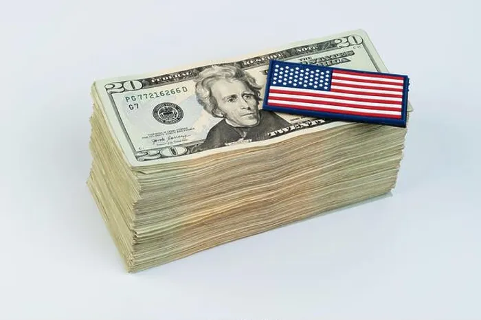 Framed Print : American flag on pile of 20 dollar banknote isolated on white studio background Framed Print : American flag on pile of 20 dollar banknote isolated on white studio background