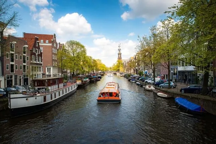 Framed Print : Amsterdam canal with cruise ship with Netherlands traditional house in Amsterdam, Netherlands. Landscape and culture travel, or historical building an Framed Print : Amsterdam canal with cruise ship with Netherlands traditional house in Amsterdam, Netherlands. Landscape and culture travel, or historical building an