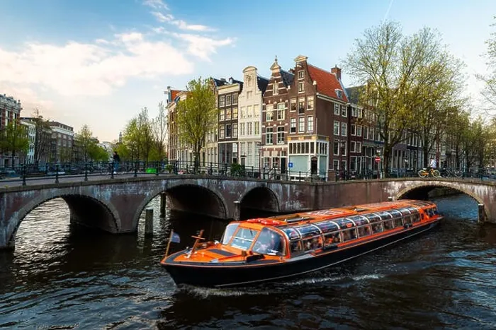 Framed Print : Amsterdam canal cruise ship with Netherlands traditional house in Amsterdam, Netherlands Framed Print : Amsterdam canal cruise ship with Netherlands traditional house in Amsterdam, Netherlands