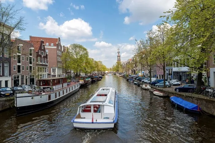 Framed Print : Amsterdam canal cruise ship with Netherlands traditional house in Amsterdam, Netherlands Framed Print : Amsterdam canal cruise ship with Netherlands traditional house in Amsterdam, Netherlands