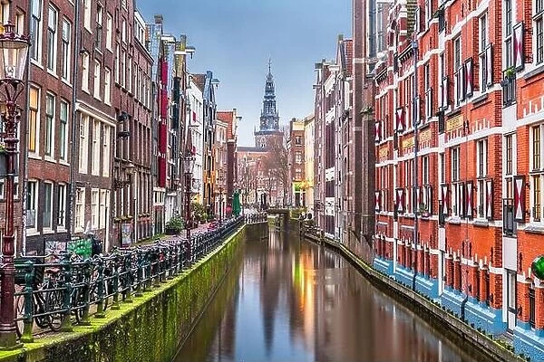 Amsterdam, Netherlands canals and church tower at dawn