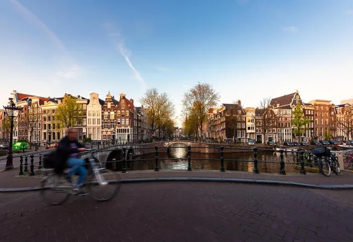 Framed Print : Amsterdam people riding bicycles in historical part in Amsterdam, Netherlands Framed Print : Amsterdam people riding bicycles in historical part in Amsterdam, Netherlands