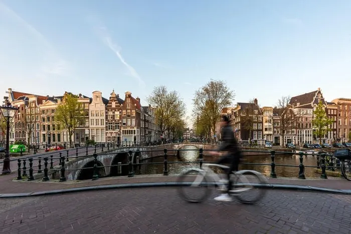 Framed Print : Amsterdam people riding bicycles in historical part in Amsterdam, Netherlands Framed Print : Amsterdam people riding bicycles in historical part in Amsterdam, Netherlands