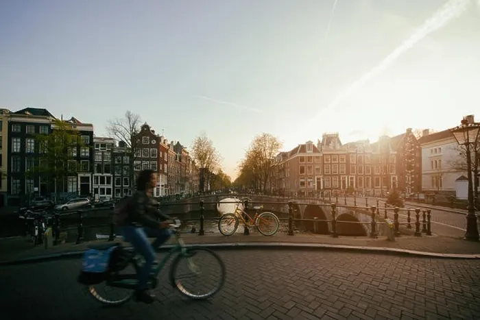 Framed Print : Amsterdam people riding bicycles in historical part in Amsterdam, Netherlands Framed Print : Amsterdam people riding bicycles in historical part in Amsterdam, Netherlands