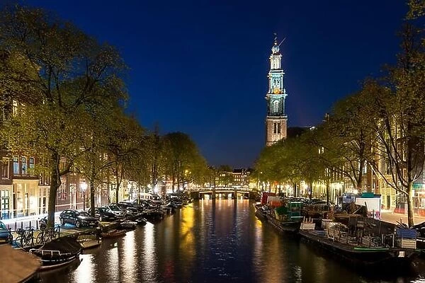 Amsterdam Westerkerk church tower at canal in the city of Amsterdam, Netherlands