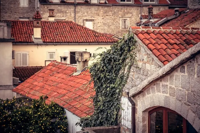 Framed Print : Ancient building facade in old European city with orange tile roofs with antique exterior in retro vintage style Framed Print : Ancient building facade in old European city with orange tile roofs with antique exterior in retro vintage style
